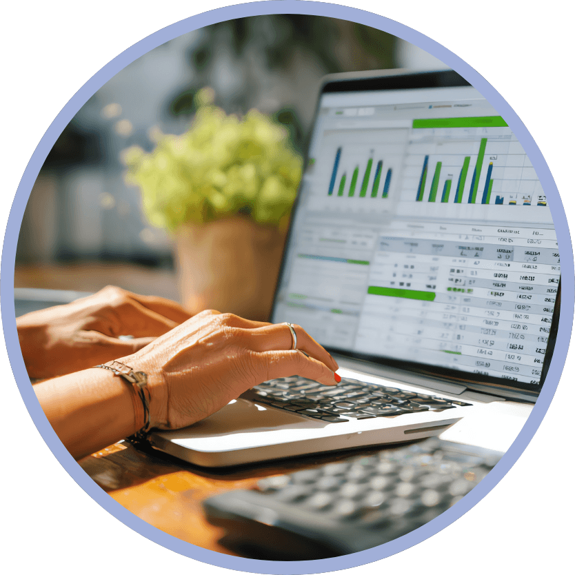 financial-clarity-circle woman's hands typing on laptop with a spreadsheet visible on the screen