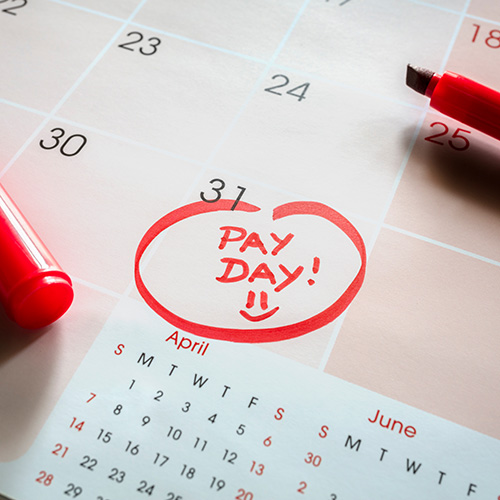 Payday end of month date on calendar with red marker and circled salary day